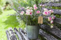 Bouquet of lavender and roses in a tin bucket on a bench - Lavender summer party story