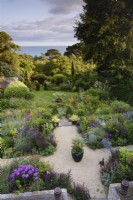 View over a sloping garden towards the sea in July