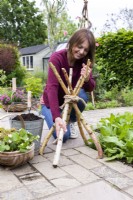 Woman spreading sticks out to create stand