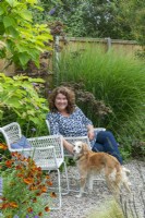 Christine Wilford, garden designer, in her suburban back garden with her dog, Wanda.