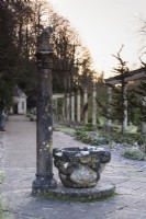 Italian font and column on The Great Terrace at Iford Manor, Wiltshire in January