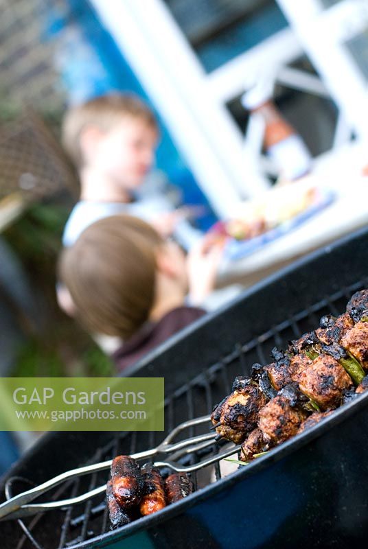Barbecue with children in the background