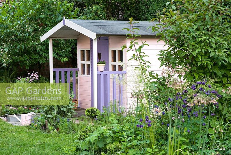 Painted pink and lilac wendy house