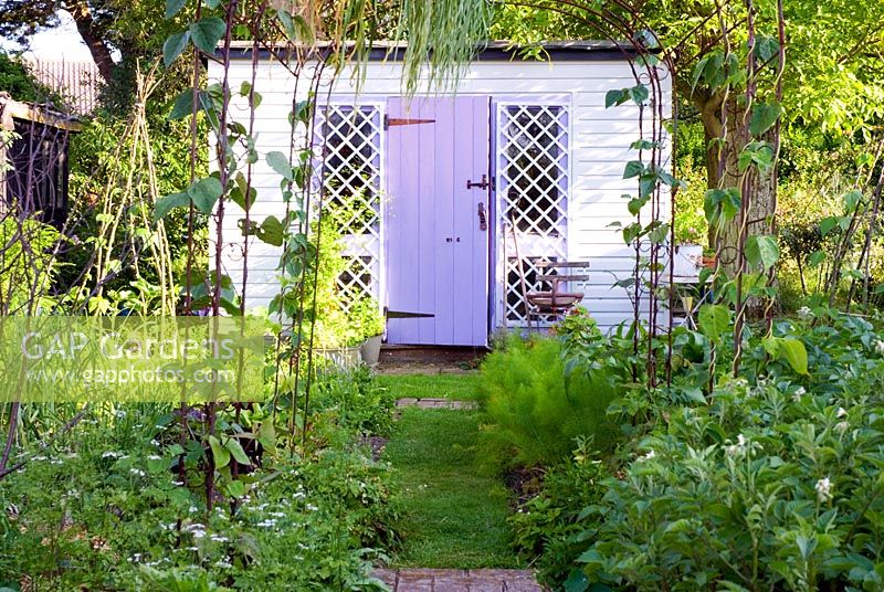 Painted garden shed in vegetable garden