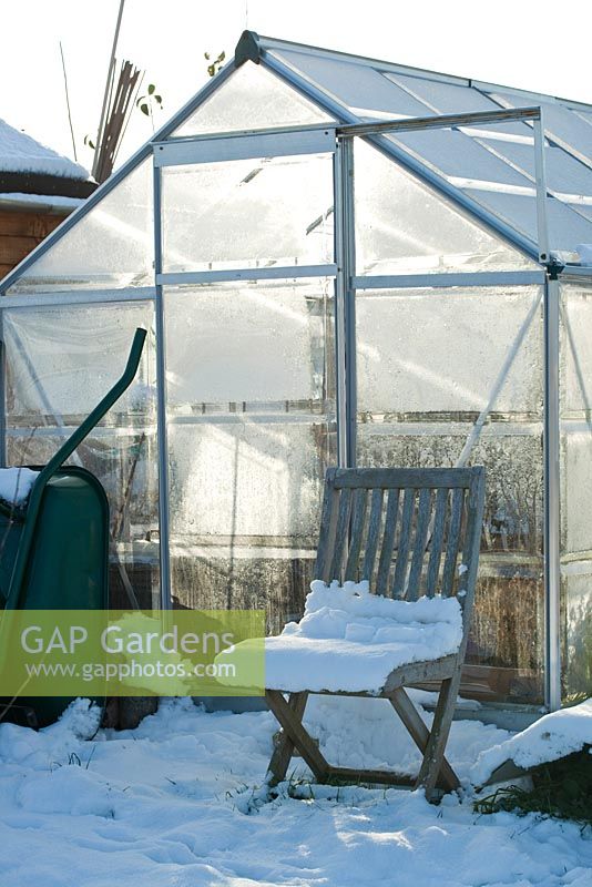 Allotment greenhouse in snow, winter