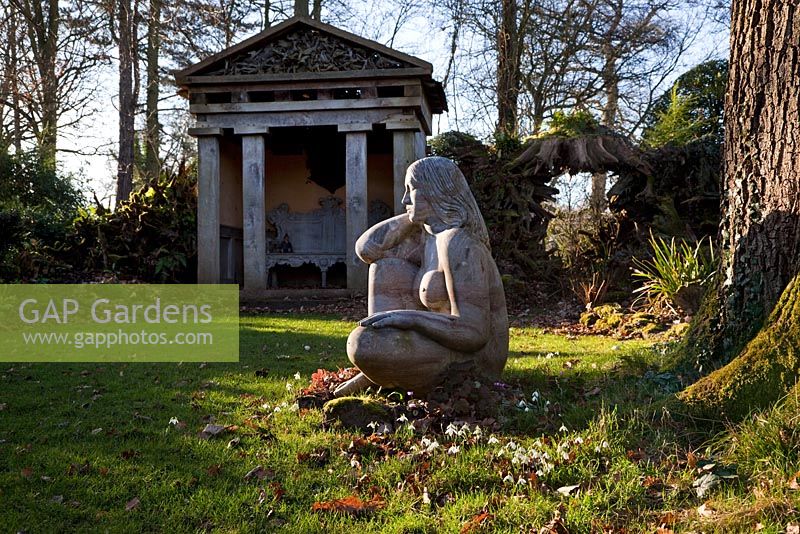 'Goddess of the Woods' statue and one of the two green oak temples in the Stumpery, Highgove Garden, February 2011