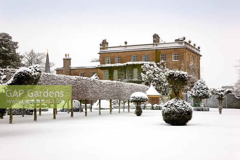Oblique view of the west front with hedges and topiary at Highgrove, covered in snow, January 2010.  