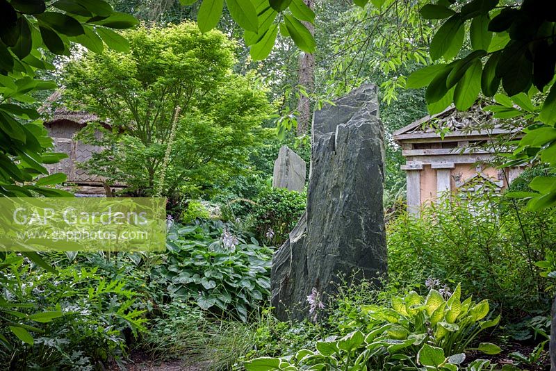 Welsh slate and Green Oak Temple in the Stumpery, Highgrove Garden August 2012. The Stumpery is based on a Victorian concept for growing ferns amongst tree stumps. 