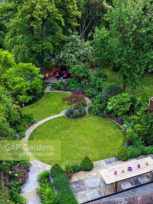An aerial view of a lawn in modern town garden laid out on a circular theme.