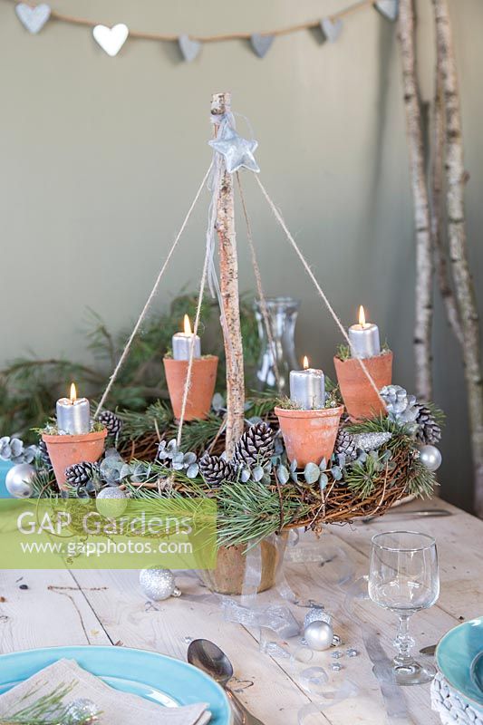 Rustic advent candle holder lit with table place settings