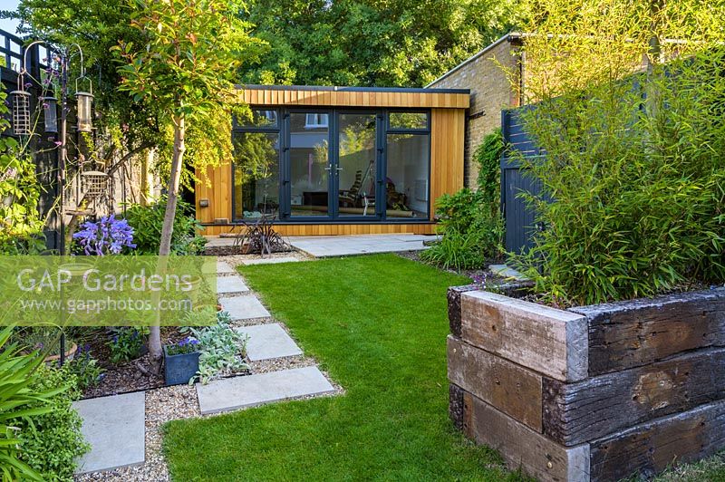 Walthamstow Modern Garden with Raised Bed and Garden Room by Earth Designs 