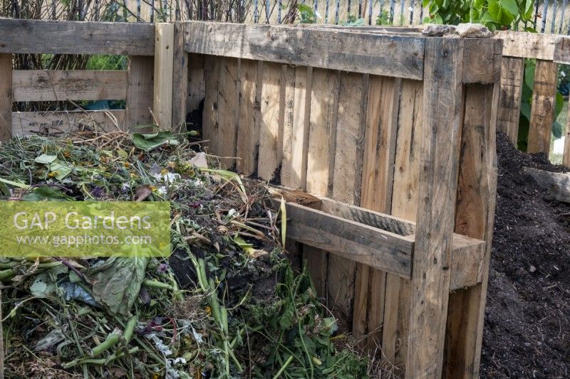 Two compost bays made from recycled wooden pallets.