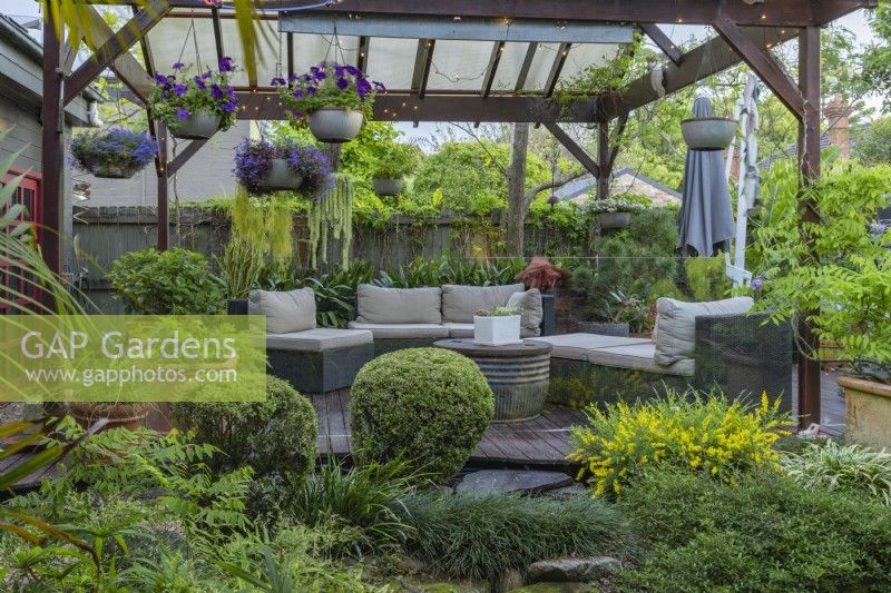 Outdoor entertaining area featuring potted plants and outdoor furniture.