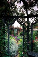 View through trellis summerhouse to opening in wall at Wollerton Old Hall