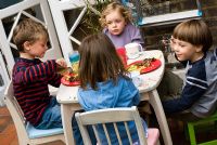 Children eating outside at a barbecue