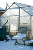 Allotment greenhouse in snow, winter