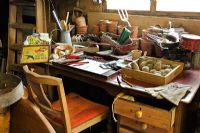 Gardeners desk in a large potting shed with seeds, seed potatoes, and gardening items, Norfolk, UK, March