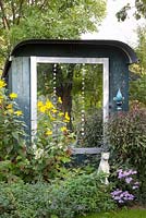 Mirror placed on trailer and used as a summerhouse