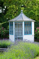 Blue and white summerhouse with lavender