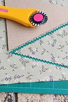 Step by step of making garden bunting - Using a triangle template, cutting out fabrics with a rotary cutter