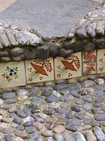 Small step decorated with Mexican tiles and pebbles 