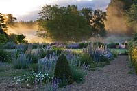 Dawn light on the river nar and the gravel garden in front of the hall. Narborough Hall Gardens, Norfolk