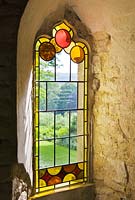 Stained glass in a window in the red house. Painswick Rococo Garden, Gloucestershire 
