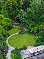 An aerial view of a lawn in modern town garden laid out on a circular theme.