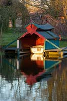 Boat house reflected in lake, Chippenham Park, Cambridgeshire.