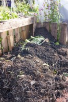 Compost heap made from recycled wooden pallets