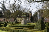 A stone urn takes centre stage in the Box, Buxus sempervirens, parterre at Helmingham Hall.