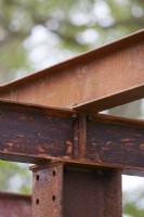 Detail of rusted metal garden structure.