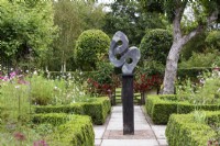 Great Responsibility by Antony Masamba forms a central focus in the parterre garden at Falkners Cottage in September