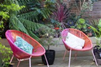Bright, circular seats add colour to the garden at April House, Gloucestershire.