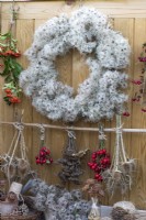 A wire wreath frame is wrapped in dried old man's beard, foraged from hedgerows and woodland along with teasels, fircones, cedar seed cones, rose hips and dried yarrow flowerheads.