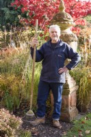 Man in his garden with rake in November