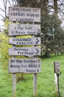 Wooden signage at Cerney House Gardens in Gloucestershire in March