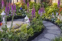 A summer bed along a stone and gravel path planted with Digitalis purpurea, Ferns and Hostas leading to a meditation area. Designer: Darragh Collopy, Bord Bia Bloom 2023