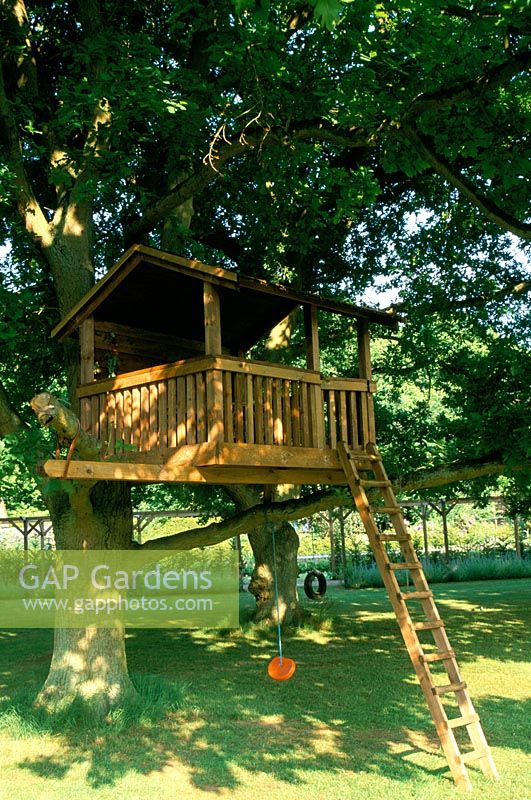 Treehouse - large wooden playhouse in tree with ladder and swings
Monkswood in Surrey