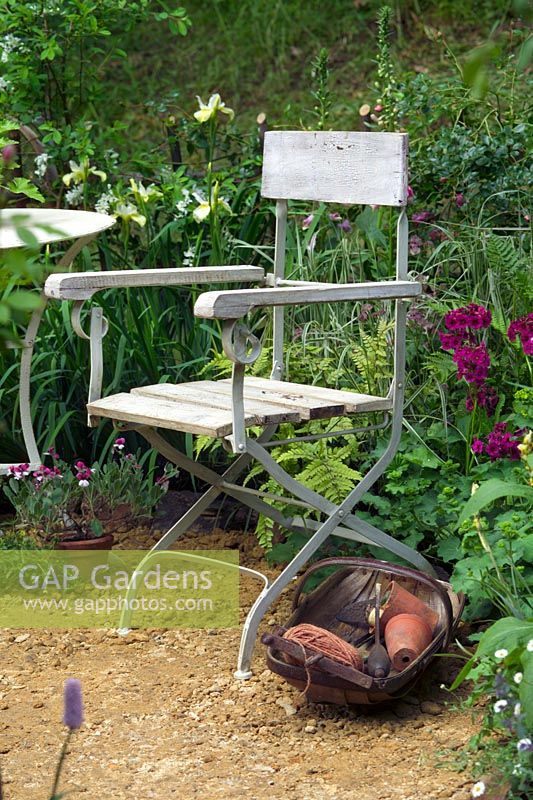 Chair in cottage garden. 'Fittleworth' by Fittleworth Society. Chelsea FS 2005