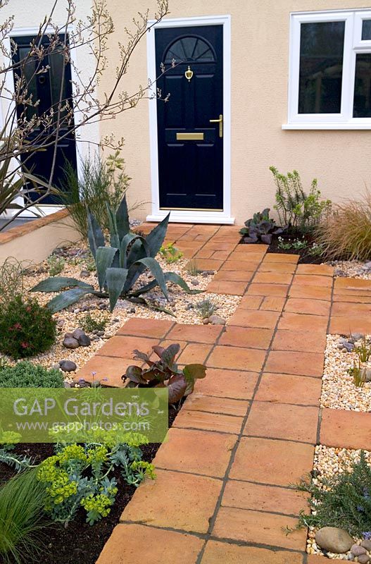 Suburban front garden with Terracotta paving and gravel at Capel Manor Show Gardens