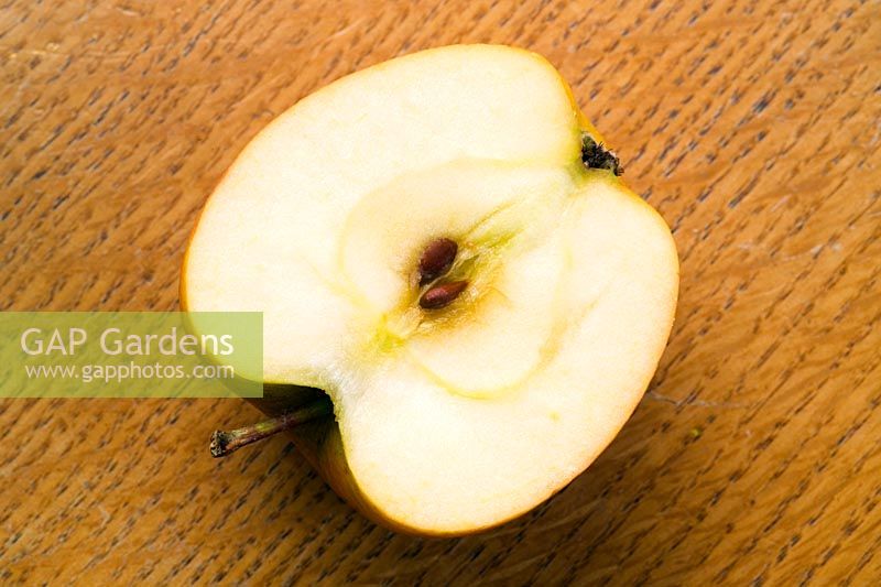 Half an apple on chopping board