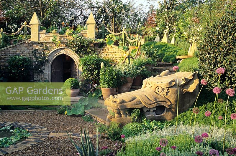 The herbalists garden showing the carved stone dragon heads with mounded body of chamomile and rosemary by Wyevale garden centre at Chelsea FS 1998