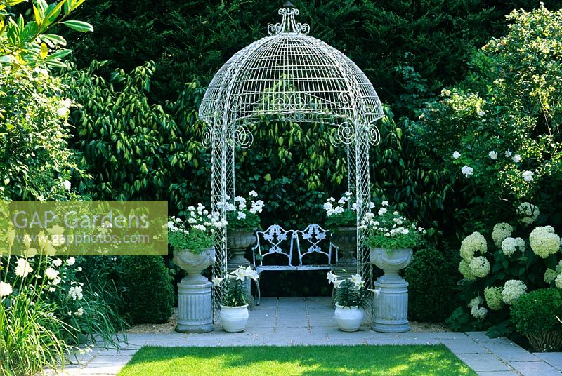 Decorative gazebo with seat at The Little Cottage