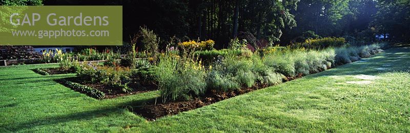 View of cut flower and vegetable garden with asparagus growing in first bed - Chanticleer Garden, Wayne, Pennsylvania, USA.
