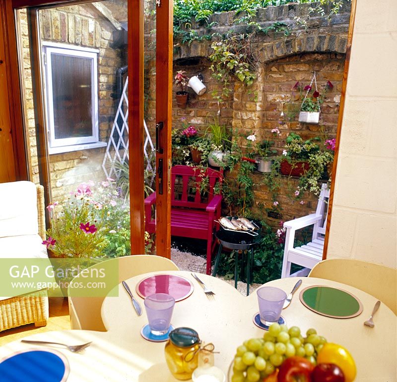 Eating area in small walled back garden   