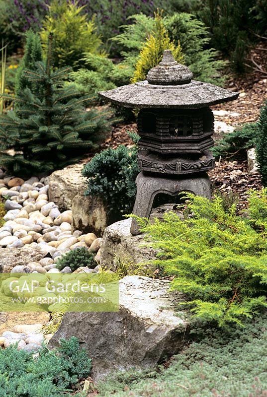 Japanese Lantern placed on rocks in Japanese garden - White Knights Buckinghamshire