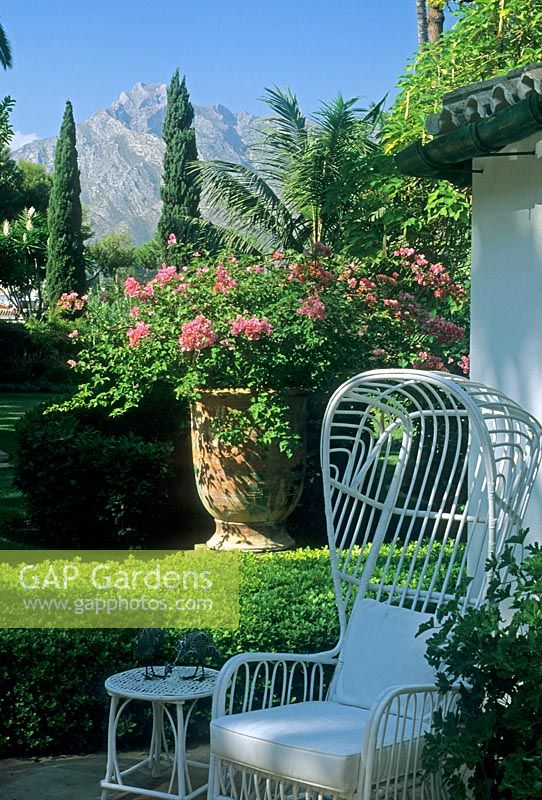 White chair and large planter with view of mountains behind - Santa Margarita, Marbella 