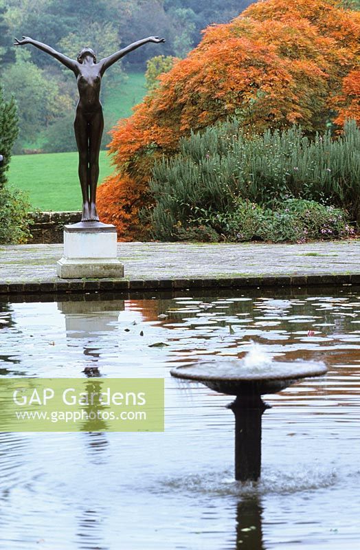The Italian garden at Borde Hill with formal rectangular pond and statue.