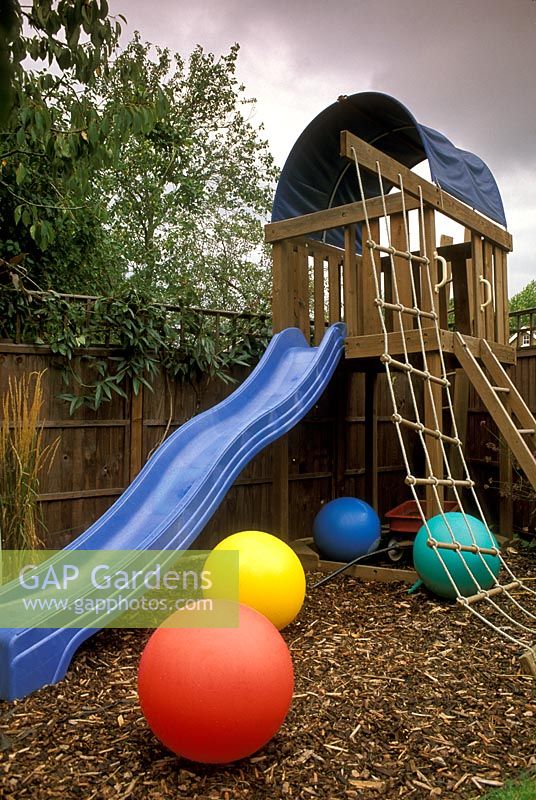 Childrens slide on bark in urban family garden